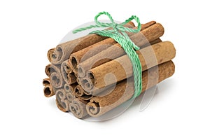 Bunch of cinnamon sticks with agreen cord