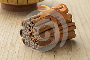 Bunch of cinnamon sticks with an orange ribbon