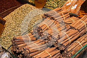 Bunch of cinnamon sticks for sale on counter top at the Christmas market