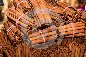 Bunch of cinnamon sticks for sale on counter top at the Christmas market