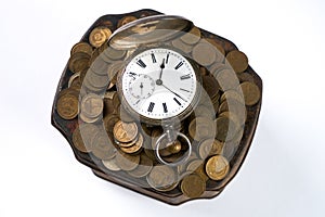 A bunch of coins with a pocket watch on top of Vintage jewelry box