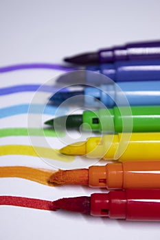 A bunch of colored markers laid out in rainbow order. stationery concept. copy space. isolated