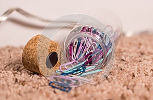 Bunch of colored paper clips in container