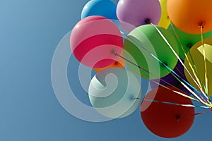 Bunch of colorful balloons against blue sky, bottom view. Space for text