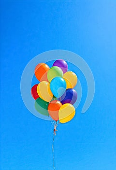 a bunch of colorful balloons with a blue sky background