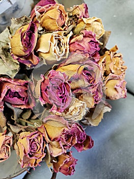 A bunch of colorful dried roses on the table