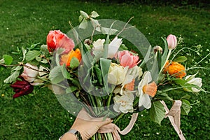 Bunch of colorful flowers.Bouquet of fresh orange pink flowers on green background.Bright bouquet shot from above.Various flowers