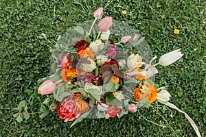 Bunch of colorful flowers.Bouquet of fresh orange pink flowers on green background.Bright bouquet shot from above.Various flowers