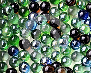 Bunch of colorful glass marbles on the white background.