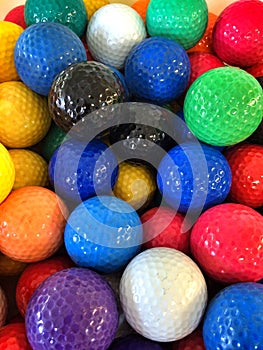 A bunch of colorful mini-golf golf balls photo