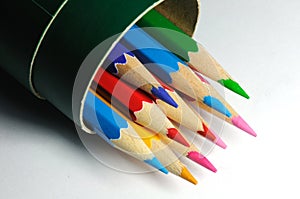 A bunch of colorful pencils in a paper container