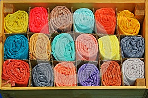 bunch of colorful silk scarves rolled piled and boxed