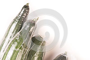 Bunch of cucumber wrapped in plastic films