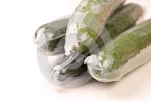 Bunch of cucumber wrapped in plastic films