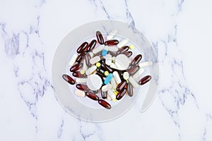 A bunch of different pills capsules and medicines on a white background. Medical theme