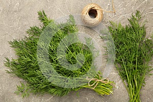 Bunch of dill on grey background. Top view. Food for vegetarians