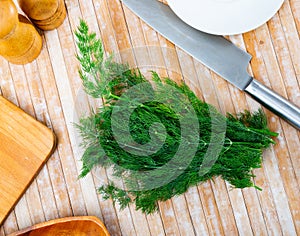Bunch of dill twigs on wooden table