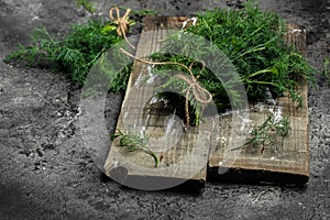 Bunch of dill in wooden box dark background. Food for vegetarians. Long banner format. top view