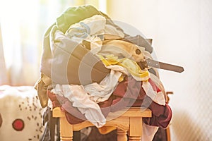 Bunch of dirty clothes pile heap on wooden surface, messy concept f