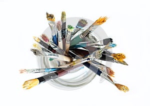 Bunch of dirty used paint brushes.  Colorful drawing accessory. Above view