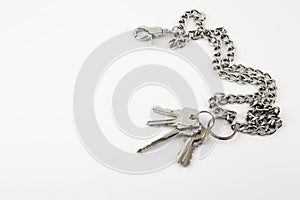 Bunch of door keys with chain isolated on white background