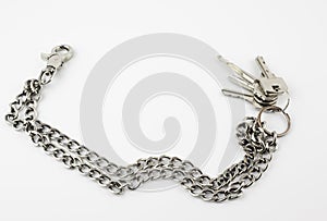 Bunch of door keys with chain isolated on white background