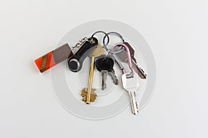 a bunch of door keys with a magnetic security key and an orange epoxy wooden keychain