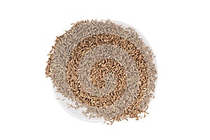 A bunch of dried aromatic cumin seeds isolated on a white background.