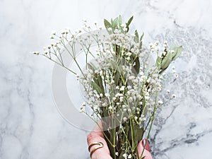 Bunch of dried flowers and eucaliptus branches on marble background