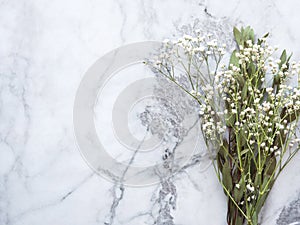 Bunch of dried flowers and eucaliptus branches on marble background