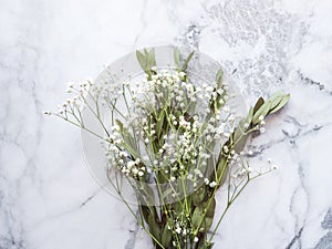 Bunch of dried flowers and eucaliptus branches on marble background