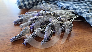 A bunch of dried Lavender with a checkered Blue and White teatowel