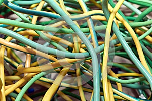 A bunch of electric yellow-green wires or cables crossed with each other.