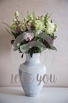 Bunch of elegant flowers in vase as love or Valentines day attribute