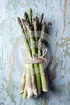 Bunch of fresh asparagus sprouts on old rusty table