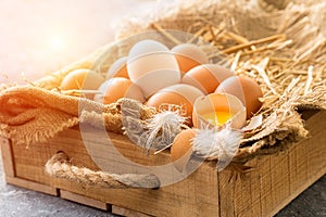 Bunch of fresh brown eggs in a wooden crate