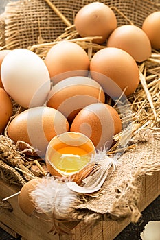 Bunch of fresh brown eggs in a wooden crate.
