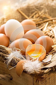 Bunch of fresh brown eggs in a wooden crate.