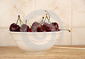 A bunch of fresh cherries in a bowl