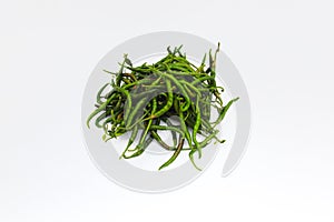 a bunch of fresh curly green chilies (Cabai Merah Keriting) isolated on white background.