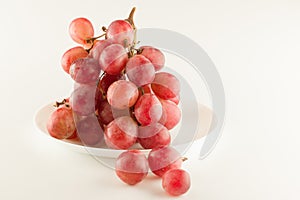 Bunch of fresh grapes lies on a dinner plate