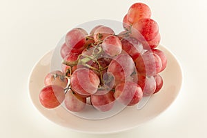 Bunch of fresh grapes lies on a dinner plate