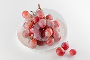 Bunch of fresh grapes lies on a dinner plate