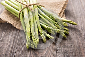 Bunch of fresh green asparagus on a rustic wooden table