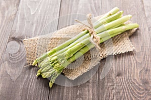 Bunch of fresh green asparagus on a rustic wooden table