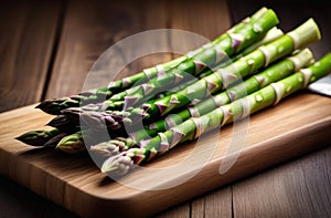 Bunch of fresh green asparagus spears on rustic wooden table.