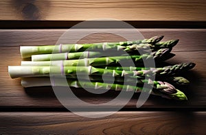 Bunch of fresh green asparagus spears on rustic wooden table. View from above