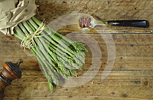 bunch of fresh green asparagus on wooden background, seasonal food and healthy eating