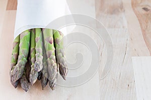 Bunch of fresh green asparagus on wooden table, horizontal, copy