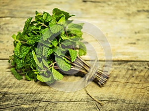Bunch of fresh green mint on wooden table